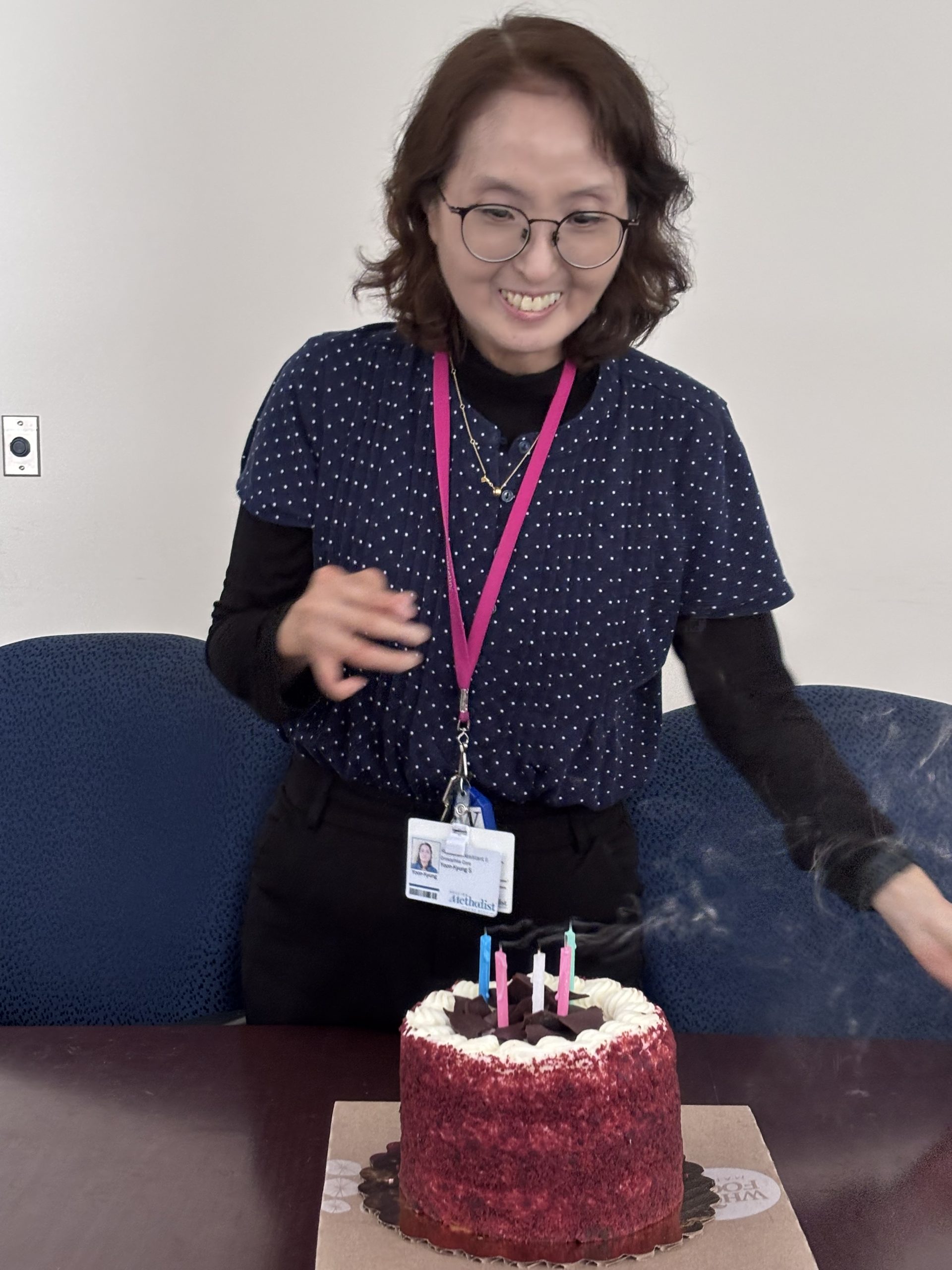 Yoon-Kyung smiling beside her birthday cake during a Chung Lab celebration.